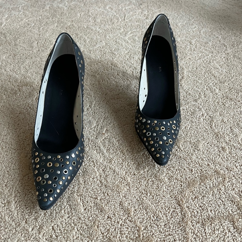 black Calvin Klein heels. Embellished with Gold, silver and brass metal eyelets.